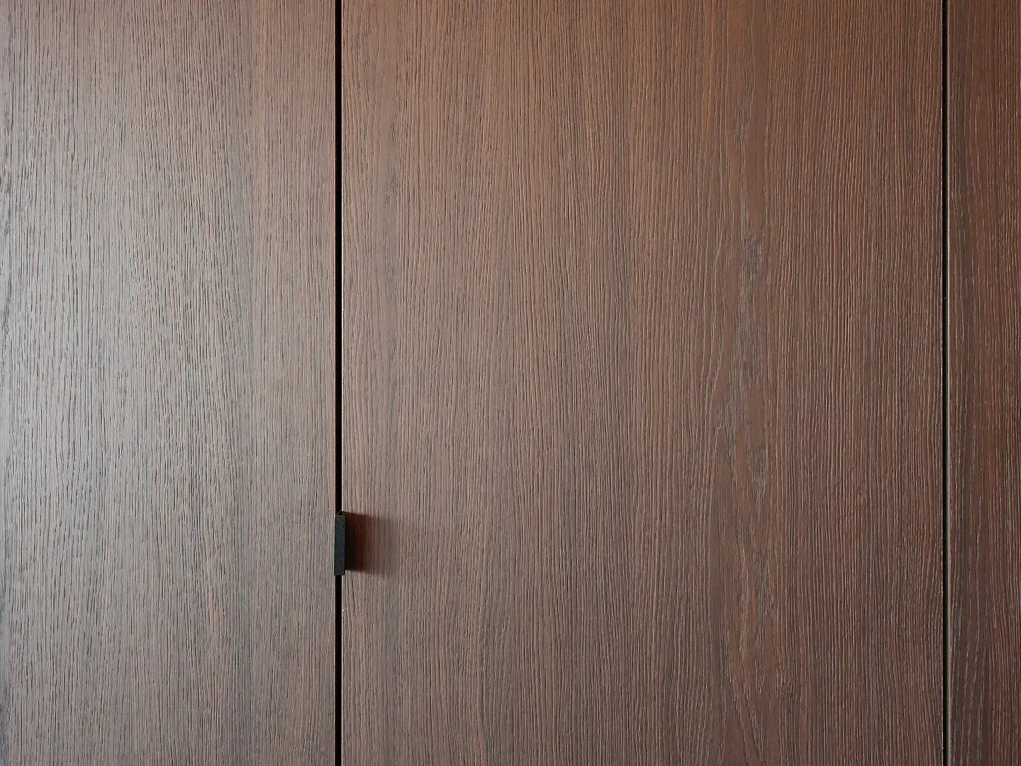 Close-up of RealGrain brunette timber-look surface showing natural wood grain texture and warm tone.
